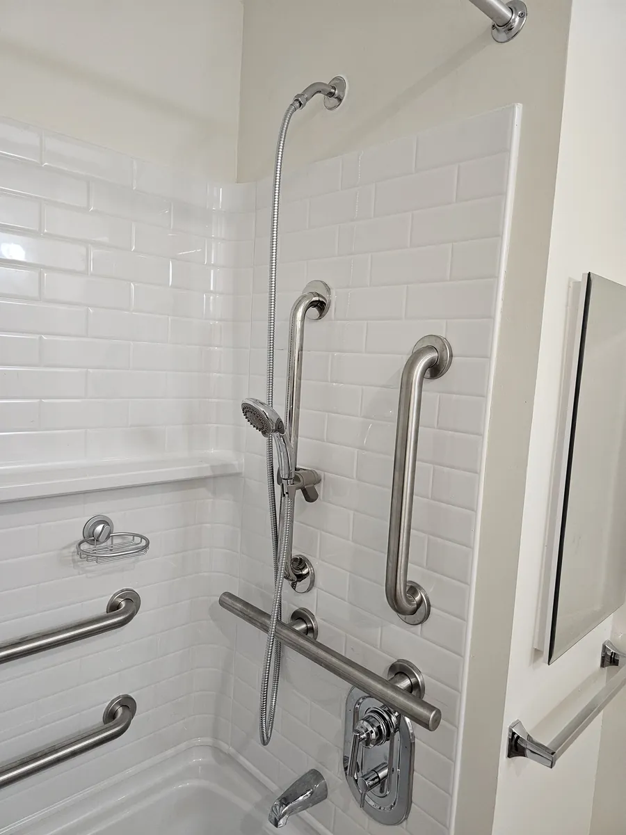 Finished tiled shower with a thermostatic valve and stainless grab bars